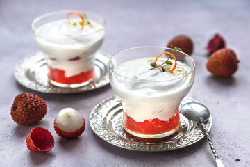 Lychee dessert with grapefruit on pink background