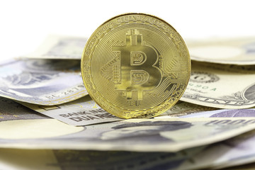 Bitcoin gold coin on bank note. Selective focus on golden. Virtual cryptocurrency concept.