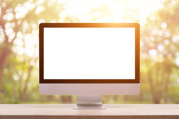 Fototapete - Modern desktop computer on wooden table and abstract light blur and bokeh background. Saved with clipping path