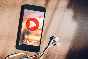 Aufkleber - mobile with viral video advertising on phone screen at blur wood table,share video on social media concept,Digital marketing strategy.