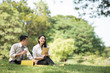 © ic36006 - Selective focus business couple relaxing with tablets in park after work done