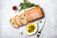 Italian Ciabatta Bread Cut In Slices With Herbs And Olives