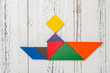 © Freer - wooden tangram shaped like a people sitting on a boat