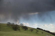 Beautiful Stormy Moody Cloudy Sky Over English Countryside Landscape At Dusk