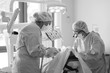 © Anna Jurkovska - Doctor and assistant during the installation of the implants to the patient in a dental clinic