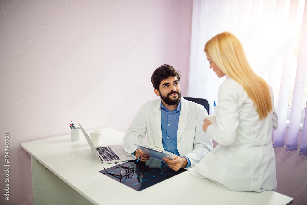Two doctors discussing about patient report in ward at hospital. Stock ...