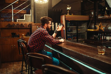 Man Sitting At The Bar Counter And Drink Alcohol