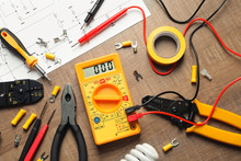 Different Electrical Tools On Wooden Background