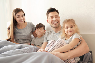 Poster - Happy family with children on bed at home