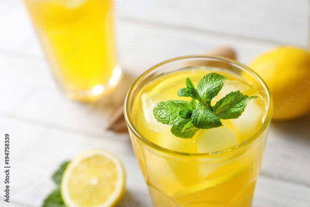 Glass of fresh lemonade on table