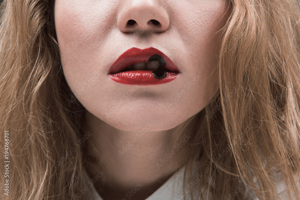 Close up of female mouth, red lips marked with injury burned out by  cigarette Stock Photo