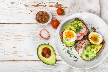 Wall Mural - Toast with avocado, radish, egg and flax seeds