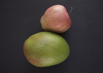 Mango and Apples on black background