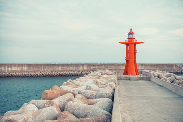 Wall Mural - View on red color lighthouse at Jeju Island - South Korea