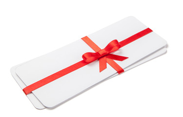 Air tickets as a gift with a red ribbon and bow. Isolated on white background; mock-up