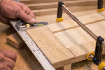 Manual manufacturing of furniture from a natural tree in a workshop.