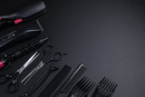 tools for haircuts and hair styling on a black background