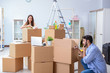 © Elnur - Young family unpacking at new house with boxes