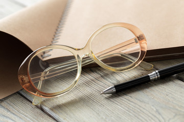 Poster - notepad and eyeglasses on the table