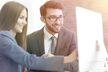 Wall Mural - colleagues discussing information on a computer