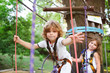 © Evgeniy Kalinovskiy - children - a boy and a girl in the rope park pass obstacles. Brother and sister climb the rope road