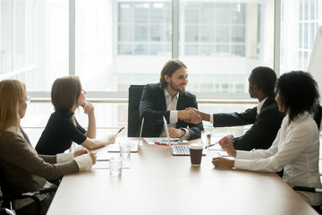 Wall Mural - company boss handshaking african american worker at corporate group meeting, ceo welcoming new hire,