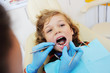 © Evgeniy Kalinovskiy - A cute, curly-haired child indulges and grimaces in a dental chair