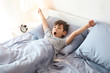 © Africa Studio - Cute little boy stretching in bed at home