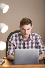 Poster - Young man working with laptop indoors