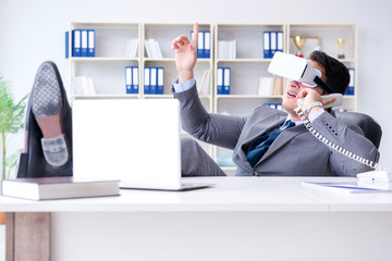 Businessman with virtual reality glasses in modern technology co