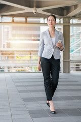 young beautiful businesswoman walking outside