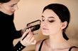 © Inna Darda - A stylist is applying makeup to a young woman