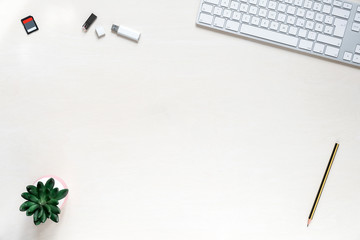 Wall Mural - copy space on white desk background with keyboard, usb sticks and sd memory card