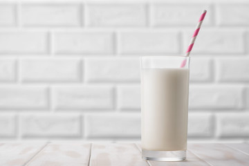 Wall Mural - Glass of milk on a white table