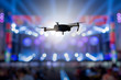 flying drone recording event by video camera at night concert