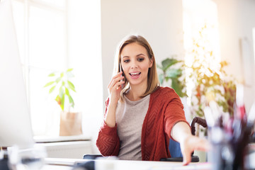 Wall Mural - Businesswoman in wheelchair at the desk in her office.