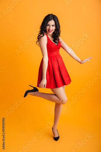 Full Length Portrait Of Fascinating Woman With Red Lips Smiling And Posing In Short Fashion Dress Isolated Over Yellow Background Stock Photo Adobe Stock