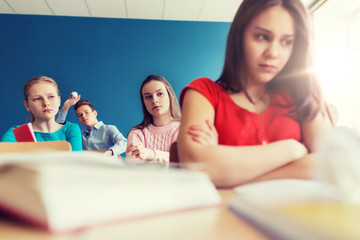 Poster - students gossiping behind classmate back at school