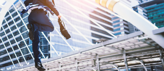 Carear Jumping running business man in front of buildings