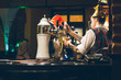 © phpetrunina14 - pub interior. evening time in bar. waiter at work