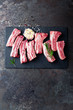© Sea Wave - Raw uncooked pork ribs, fresh meat on dark metal background. Top view. Flat lay.