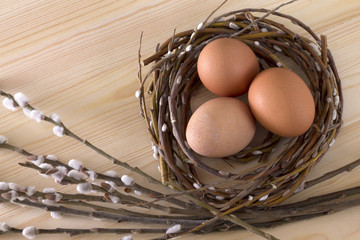 three eggs in a nest on a wooden background Easter top spring Holy Christian holiday