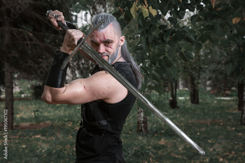 сosplay, dressed like a hero Geralt of Rivia from the game the Witcher, a fantas Poster