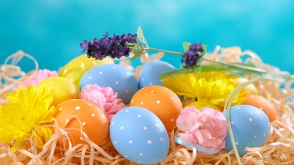 Wall Mural - Happy Easter ornaments, eggs and spring flowers on a blue and white background.