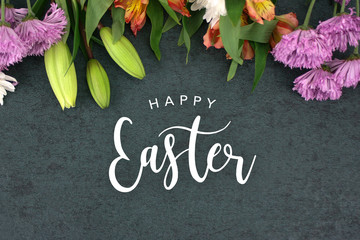 Wall Mural - happy easter text with beautiful colorful flowers bouquet border shot from directly above over black