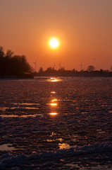 Wall Mural - Frozen River Elbe at sunset with ice floes, Hamburg Northern Germany