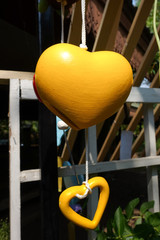 close-up image of yellow heart mobile hanging in valentine day