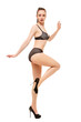 © rs31 - A beautiful woman in lingerie and high-heeled shoes balances on one leg