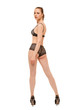 © rs31 - A young woman in lingerie and high-heeled shoes turns her face to the camera standing with her back to the viewer
