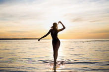 Silhouette Of Slim Sexy Woman In Bikini Walking On The Beach